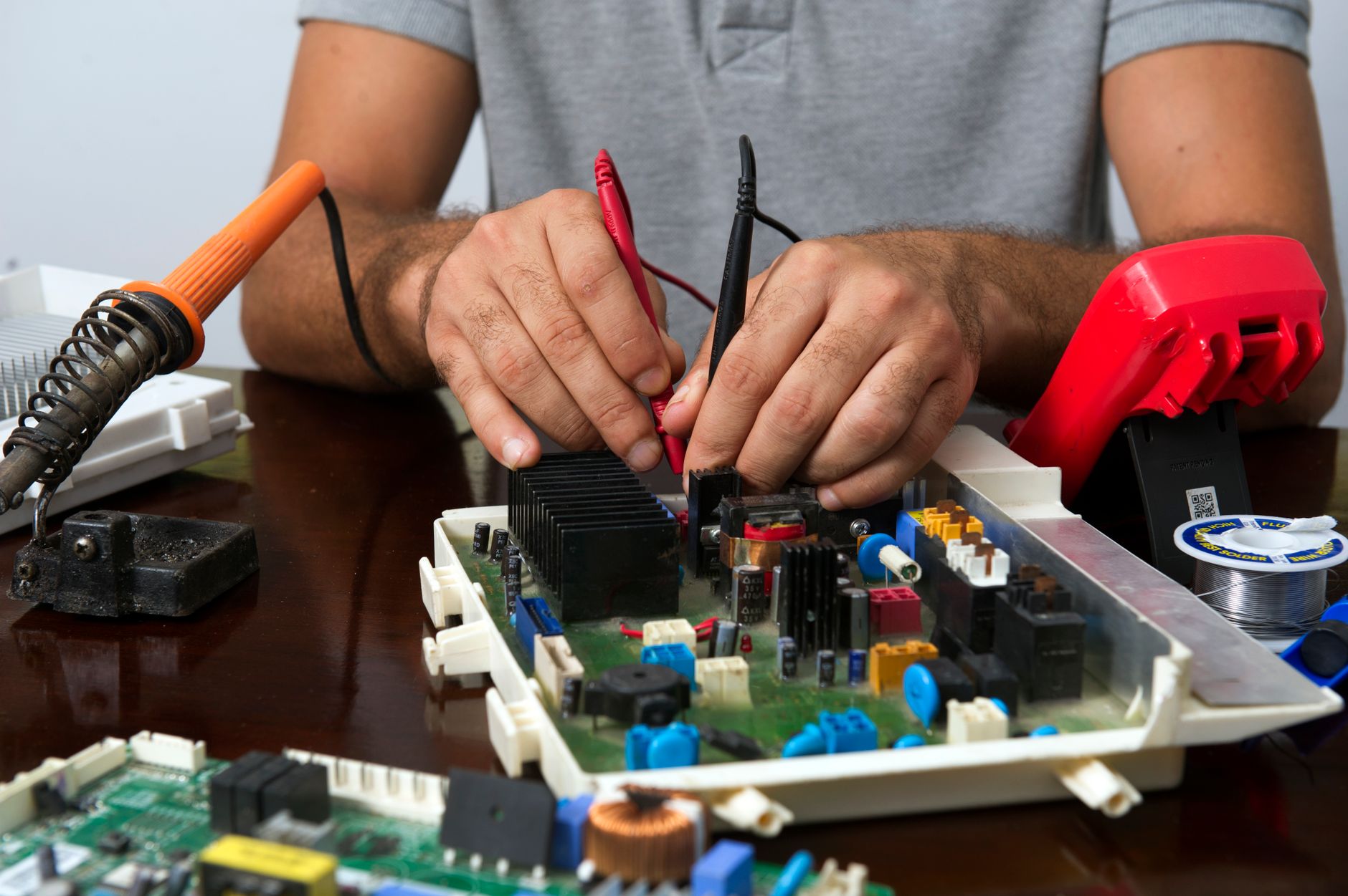 Electronics technician diagnosing and repairing CCTV equipment